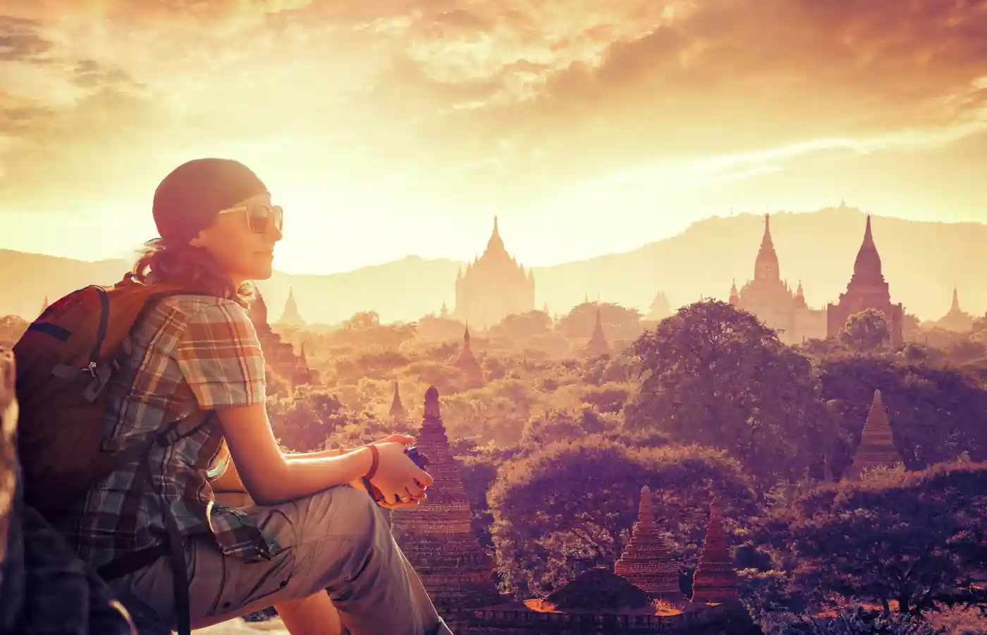 Young backpacker enjoying a looking at sunset on Bagan, Myanmar Asia.