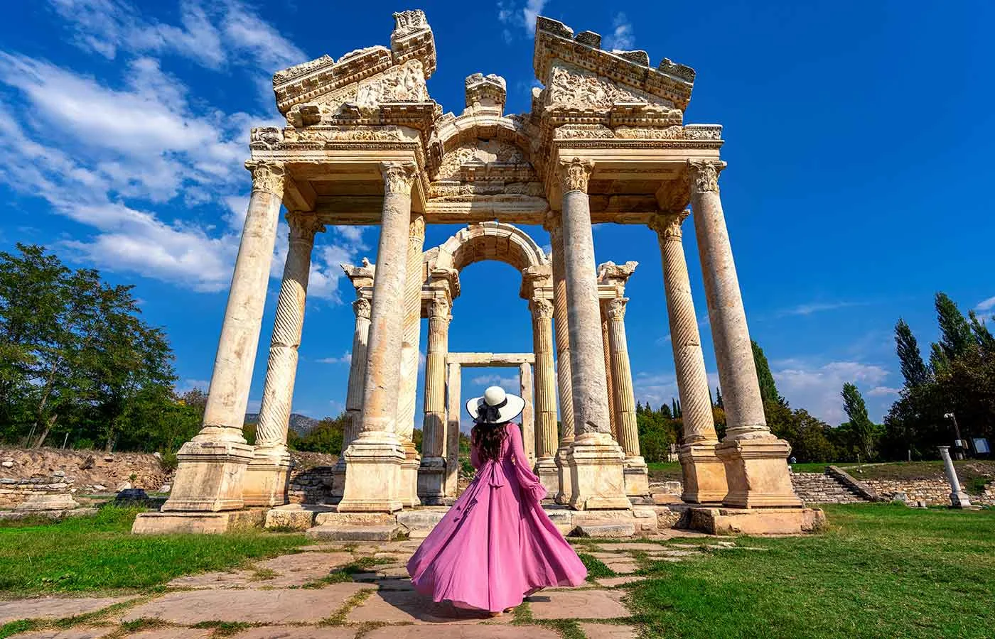 Beautiful girl walking through the ancient ruins of Aphrodisias in Turkey.