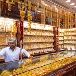 Arabic man standing at a gold shop in Dubai.