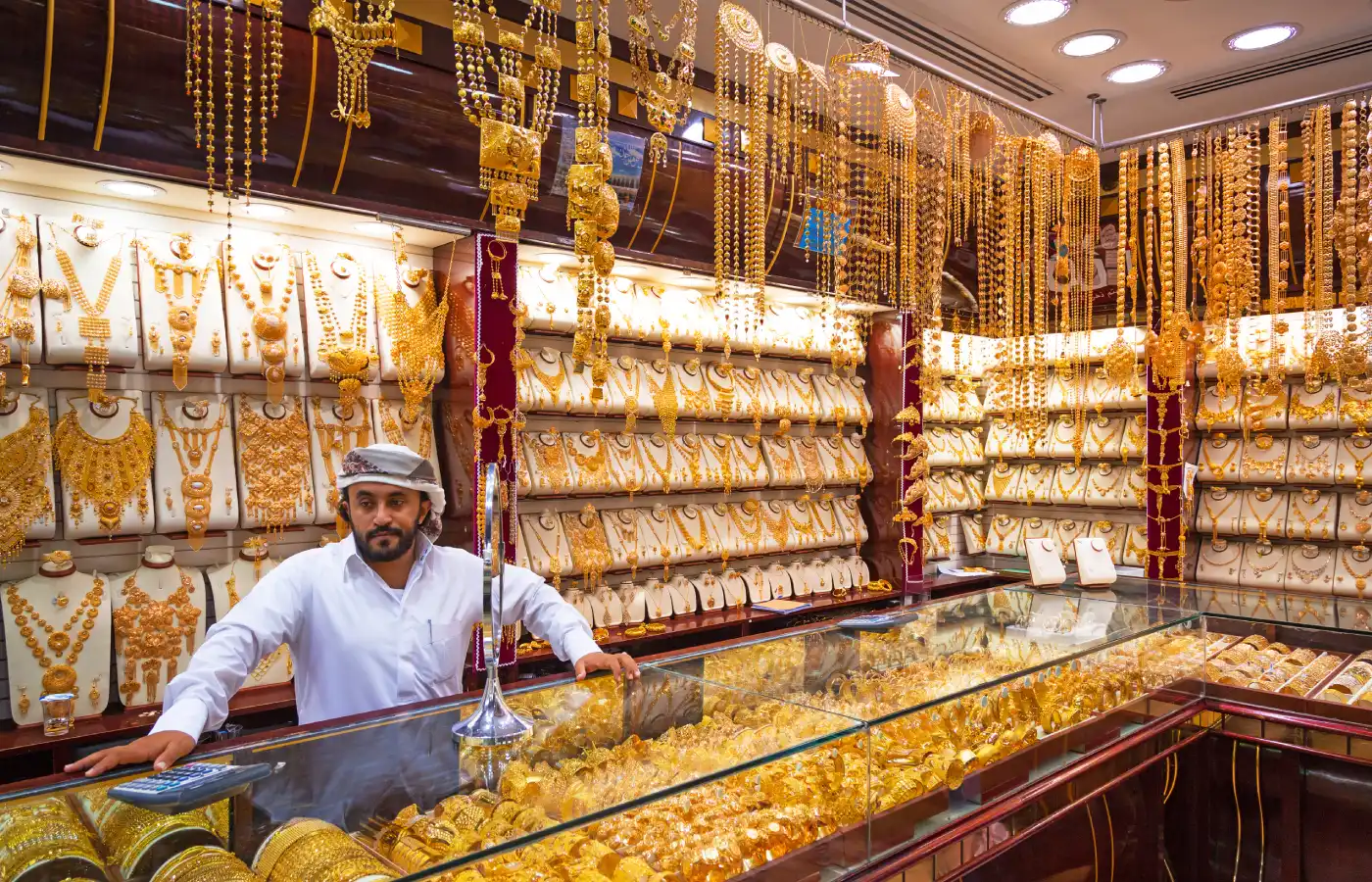 Arabic man standing at a gold shop in Dubai.