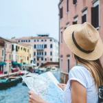 Female tourist standing on the bridge in Venice, Italy
