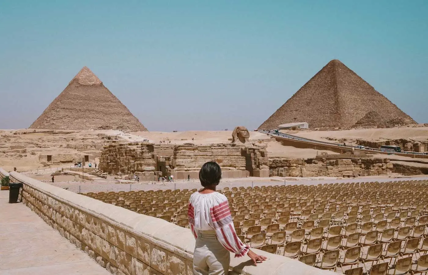 Woman standing and looking at the pyramids