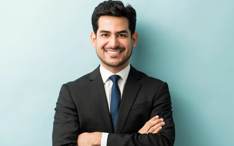 Smiling man standing in suit for photograph