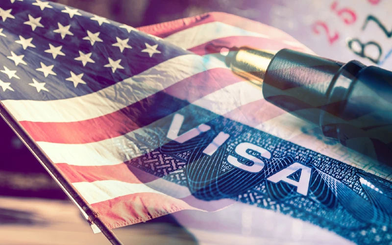 USA visa with flag in background