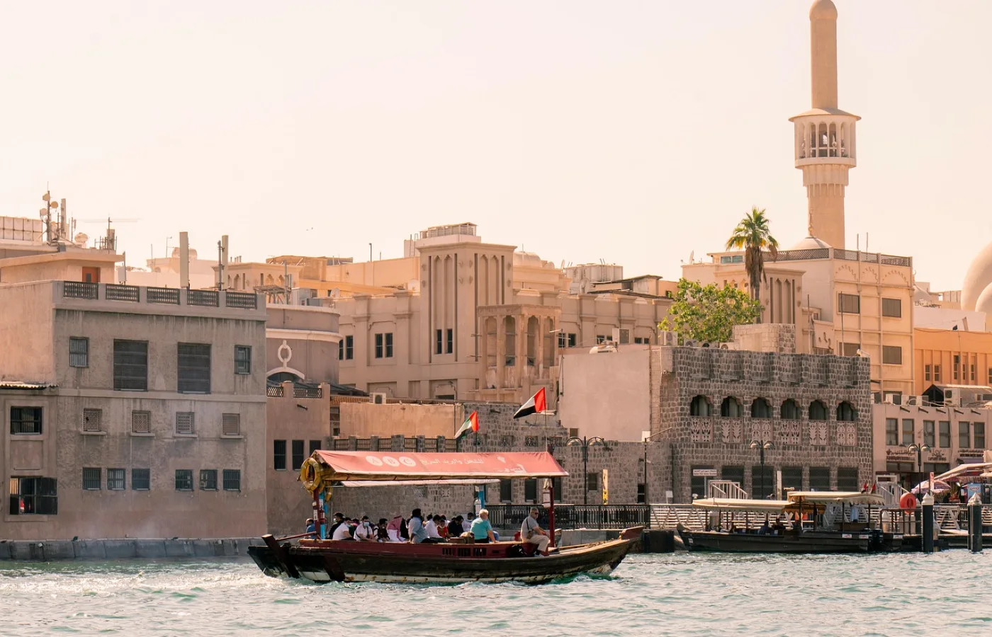 a boat passing through the architecture of old dubai