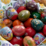a set of colorful Easter eggs displayed in a basket