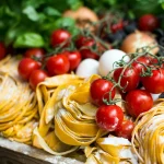 A spread of Italian pasta served with cherry tomatoes