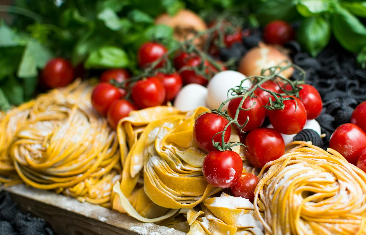 A spread of Italian pasta served with cherry tomatoes