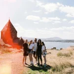 People posing on the shore near water in Armenia