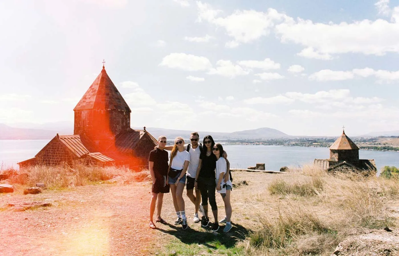 People posing on the shore near water in Armenia