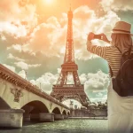 Woman tourist near the Eiffel tower in Paris.