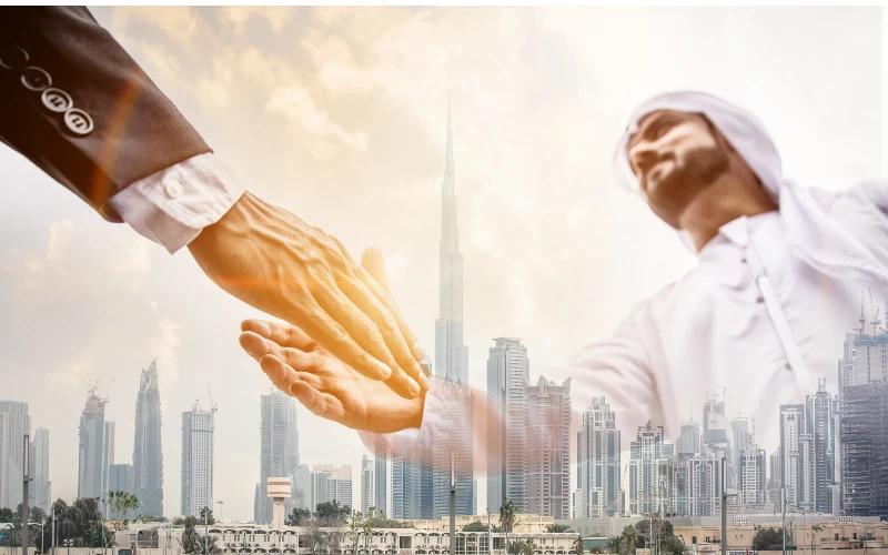 Profession shaking hands with Dubai city background