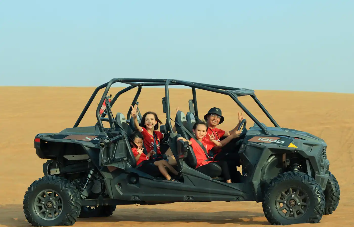 Smiling Family Riding Buggy on Desert in Dubai.