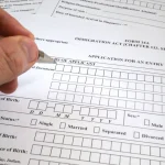 Someone filling form 14A Singapore visa