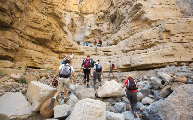 Group of hikers walking in the mountains near Dubai.