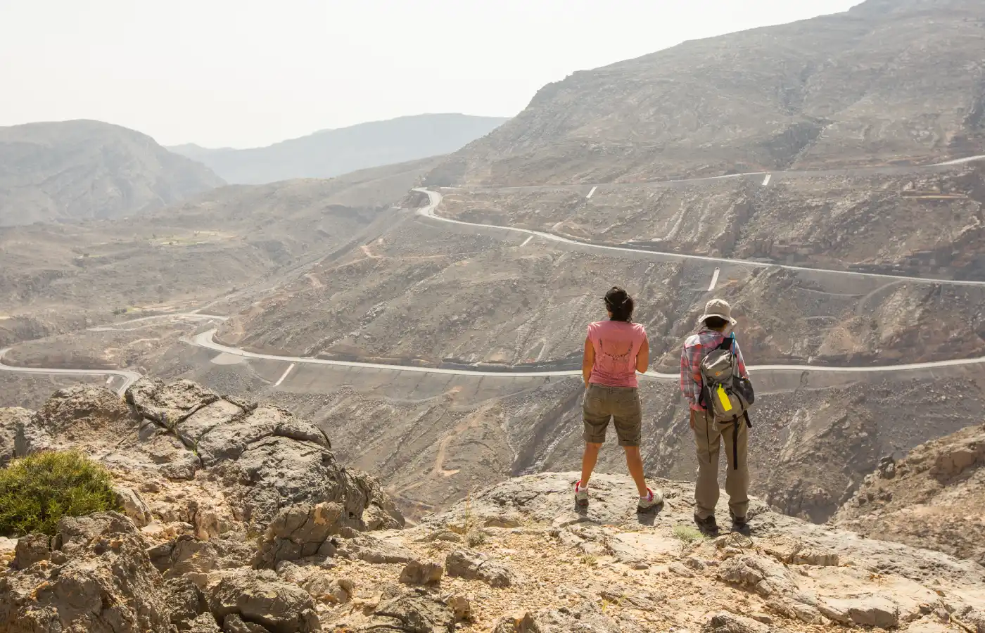 two hikers are admiring the view of mountains near Dubai