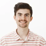 man with moustache smiling in photo