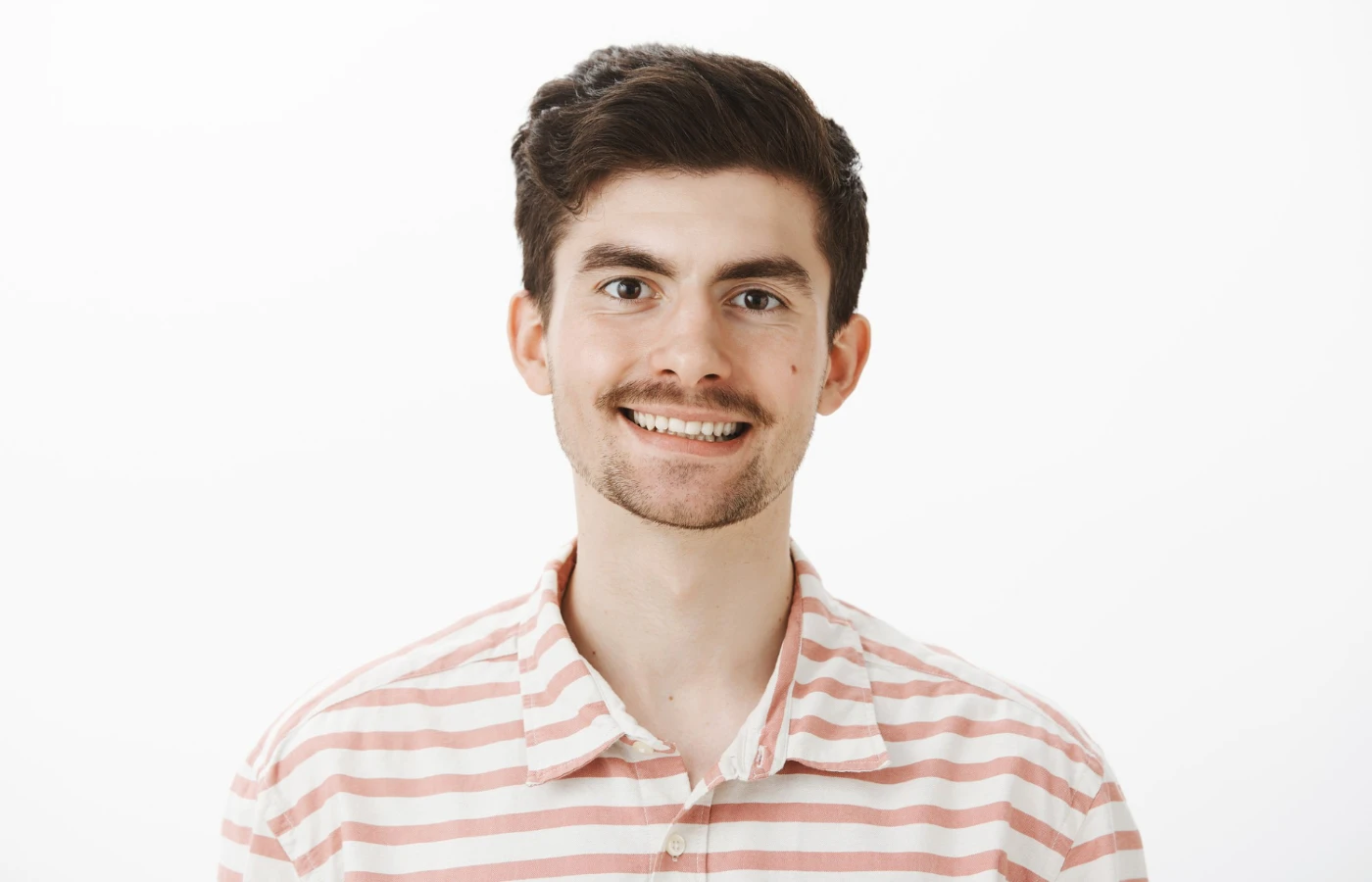 man with moustache smiling in photo