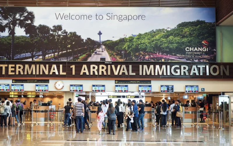 people standing Singapore immigration terminal Changi airport