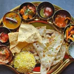vegetarian food served in a typical traditional Indian plate