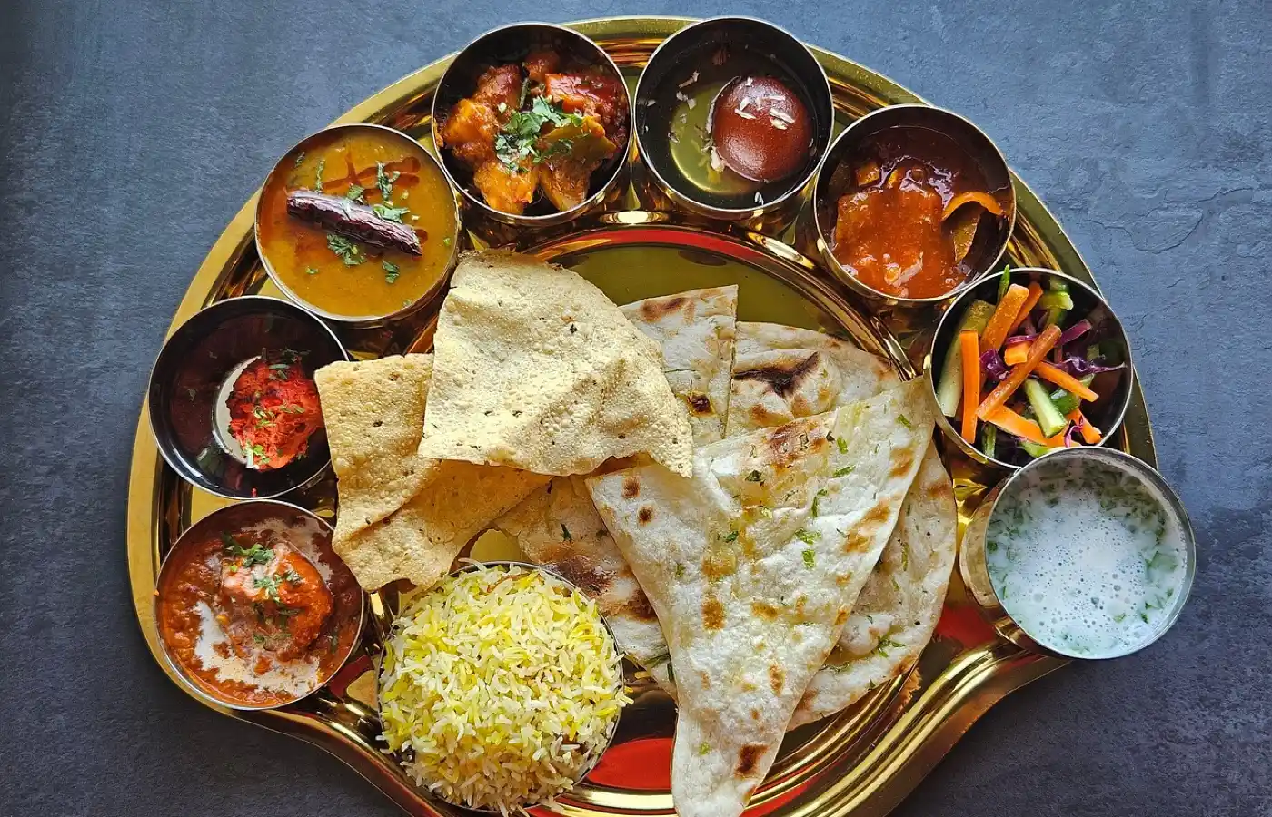 vegetarian food served in a typical traditional Indian plate