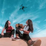 Two Women in the Dubai desert operating a drone
